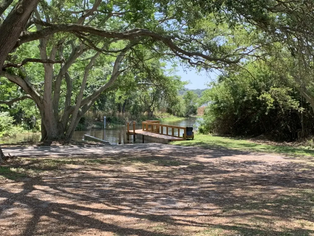 A wooden public dock reaching into a lake